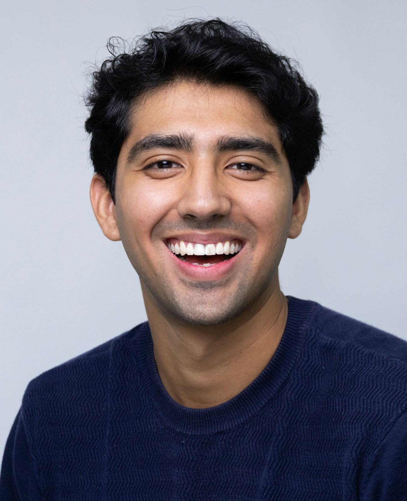 A young Indian man laughing