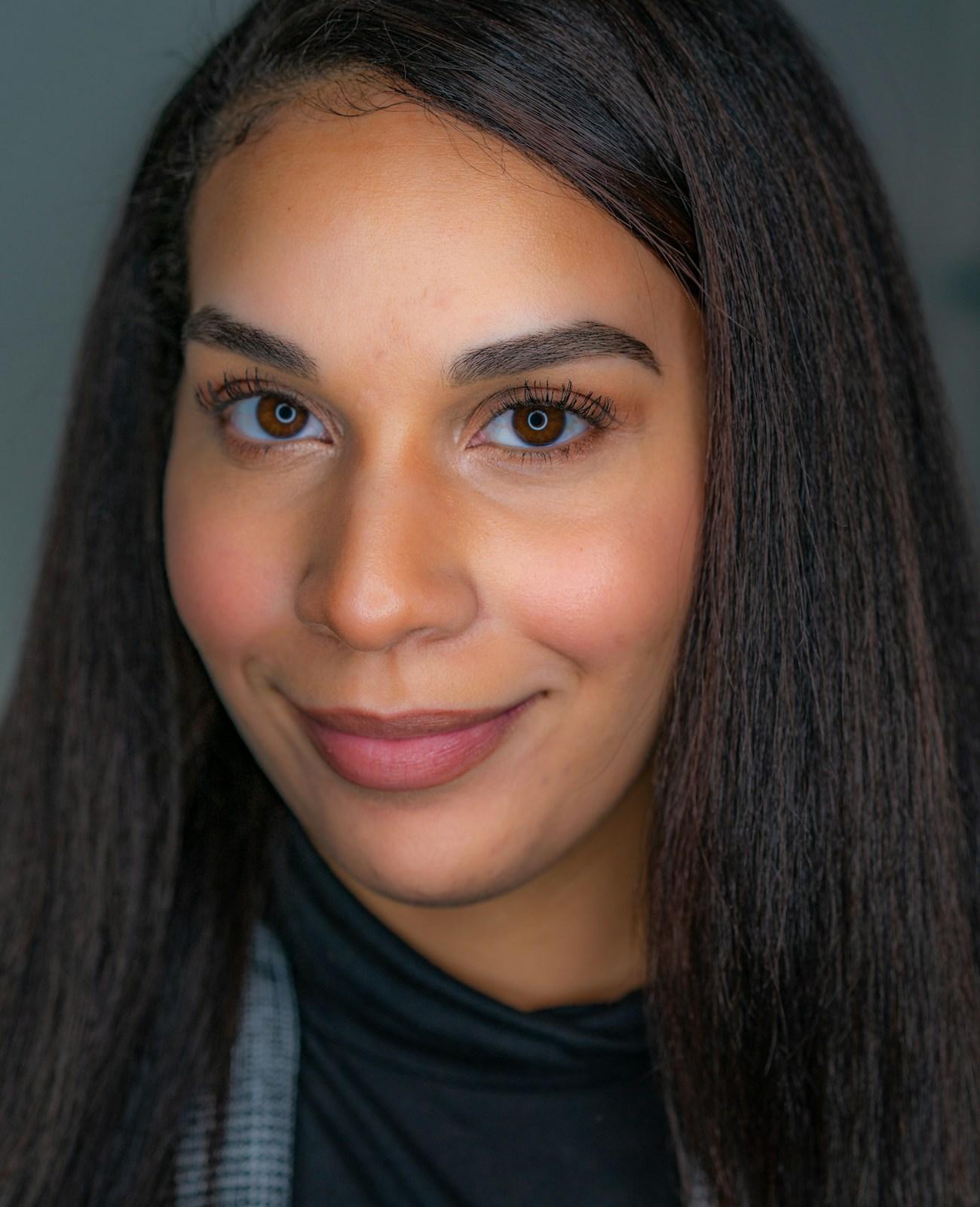 A young Indian woman with a soft smile